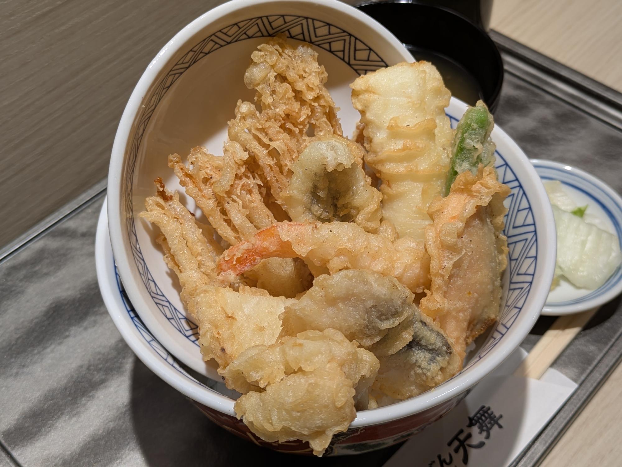 天丼専門店『天舞』の天舞天丼セット。海老や野菜の天ぷらが盛られた天丼に、味噌汁と漬物が添えられている。