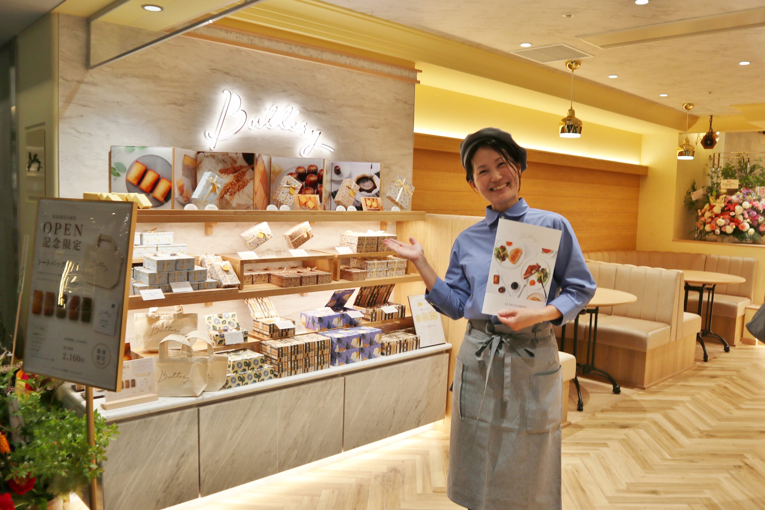 Buttery 松坂屋名古屋店の店頭で、スタッフとギフト用焼き菓子が並ぶ棚の様子